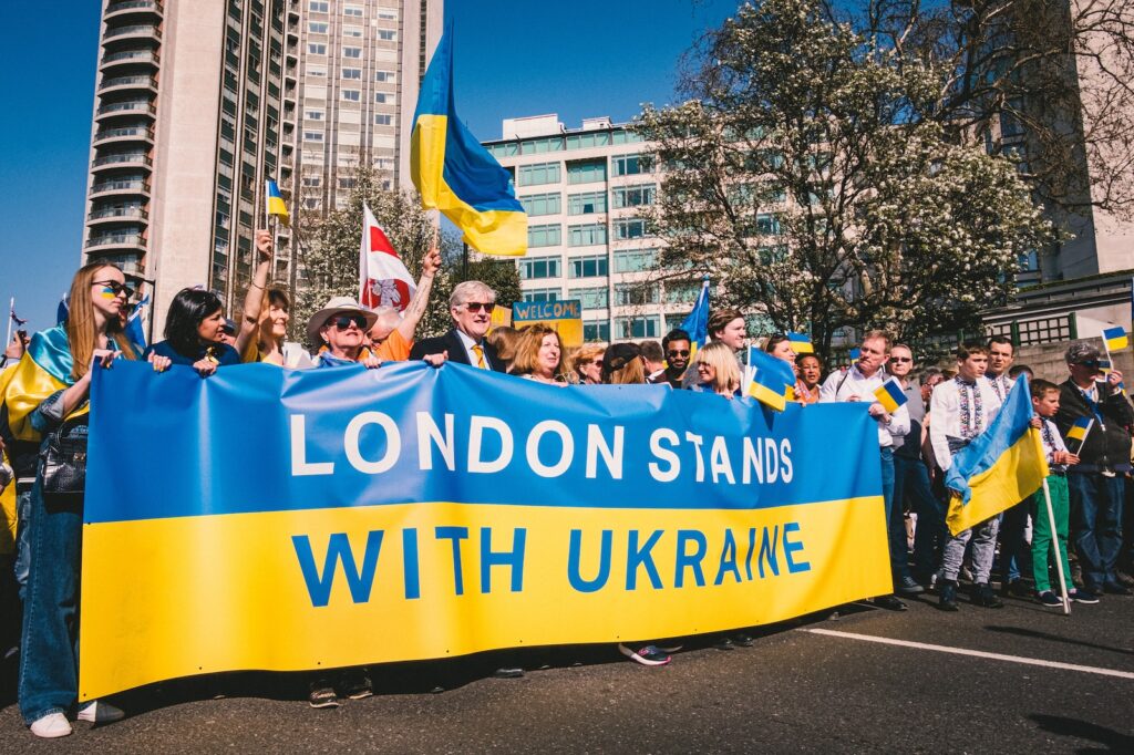 a group of people holding a blue and yellow banner