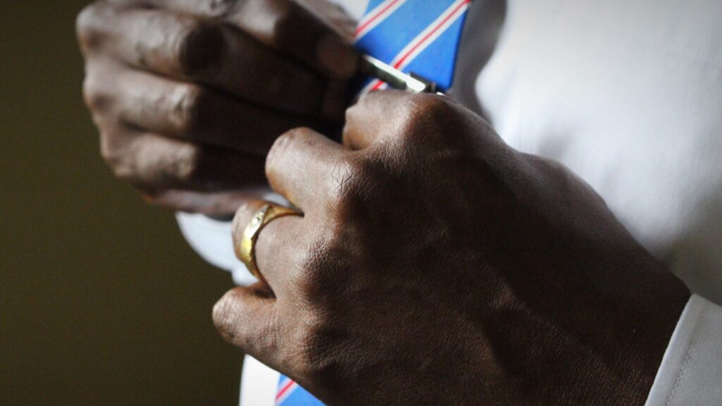 person holding blue necktie