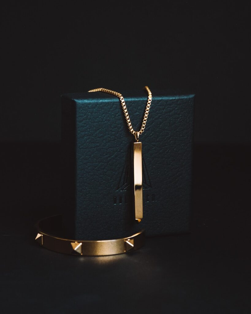 gold-colored pendant necklace